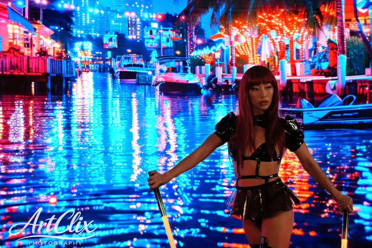 PoleLiang with glowing props against a colourful neon city scene