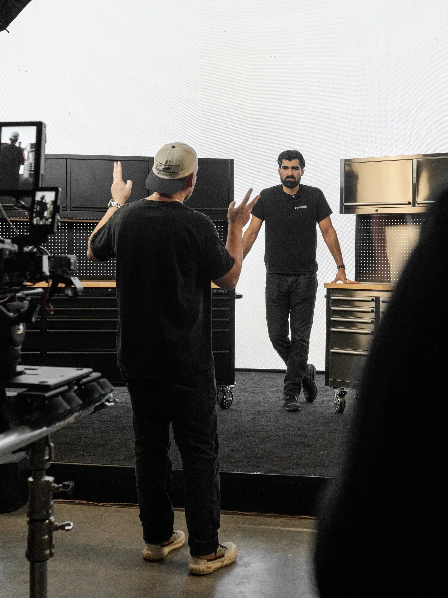 Crew direction between takes in front of the tool cabinets
