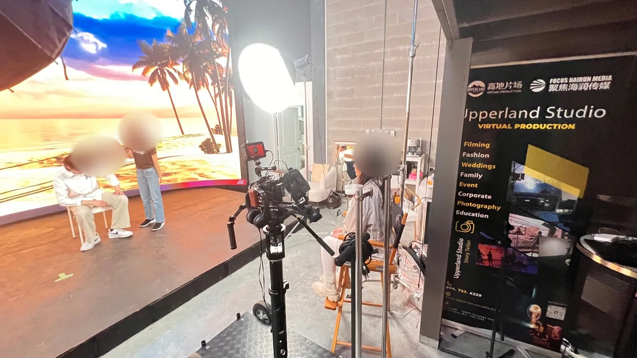 Film set with beach sunset LED backdrop, two actors and a cinema camera