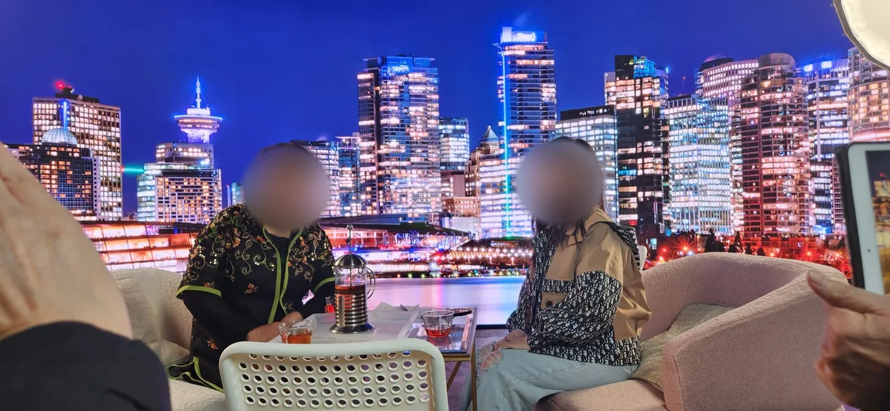 Guest and host seated before a Vancouver night skyline LED backdrop