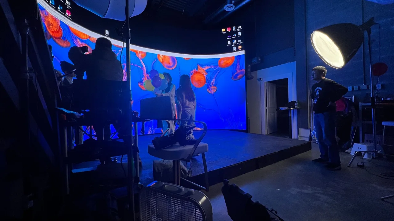 Silhouette portrait shoot before a jellyfish LED wall with balloons, behind the scenes