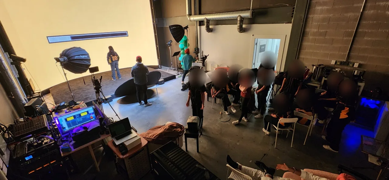 Wide shot of the Punjabi dance crew filming on the LED wall stage