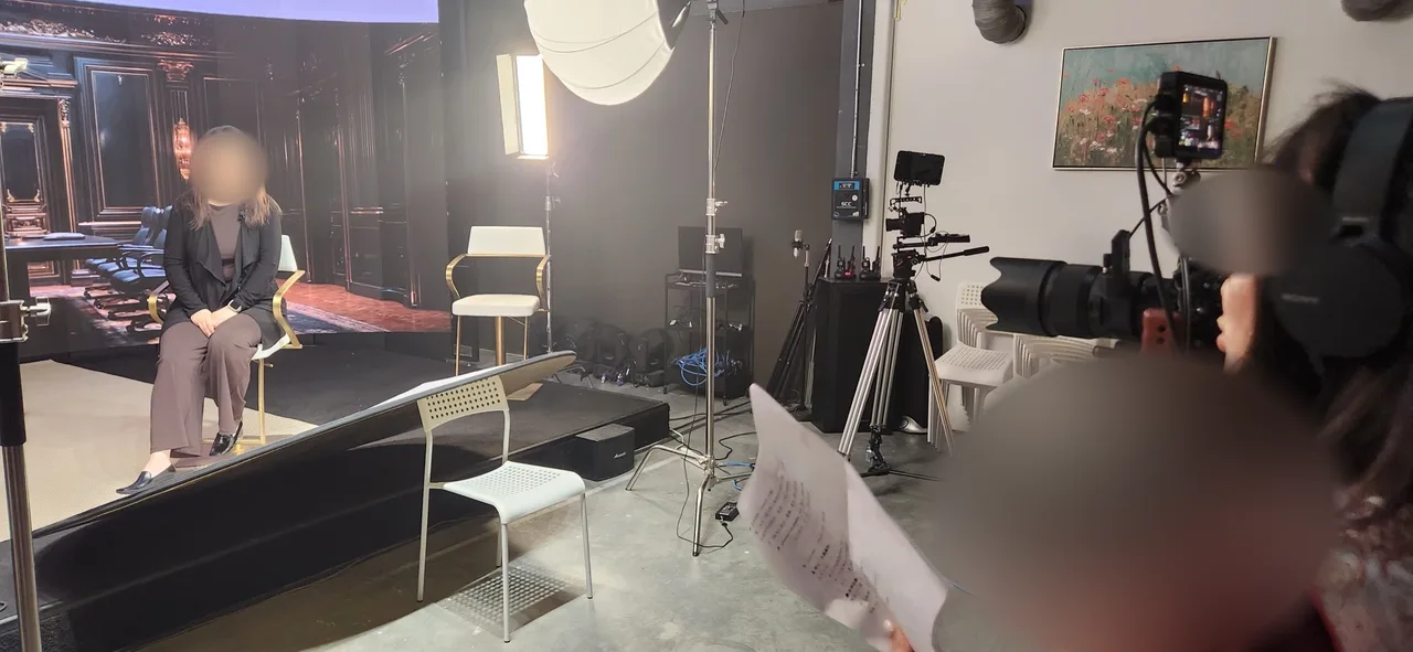 Guest seated for interview in front of the boardroom LED backdrop