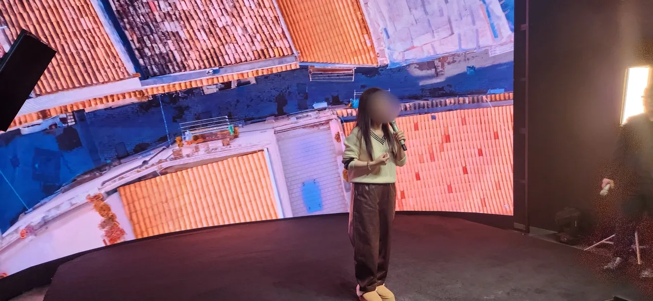 Female singer performing on stage with European city LED backdrop
