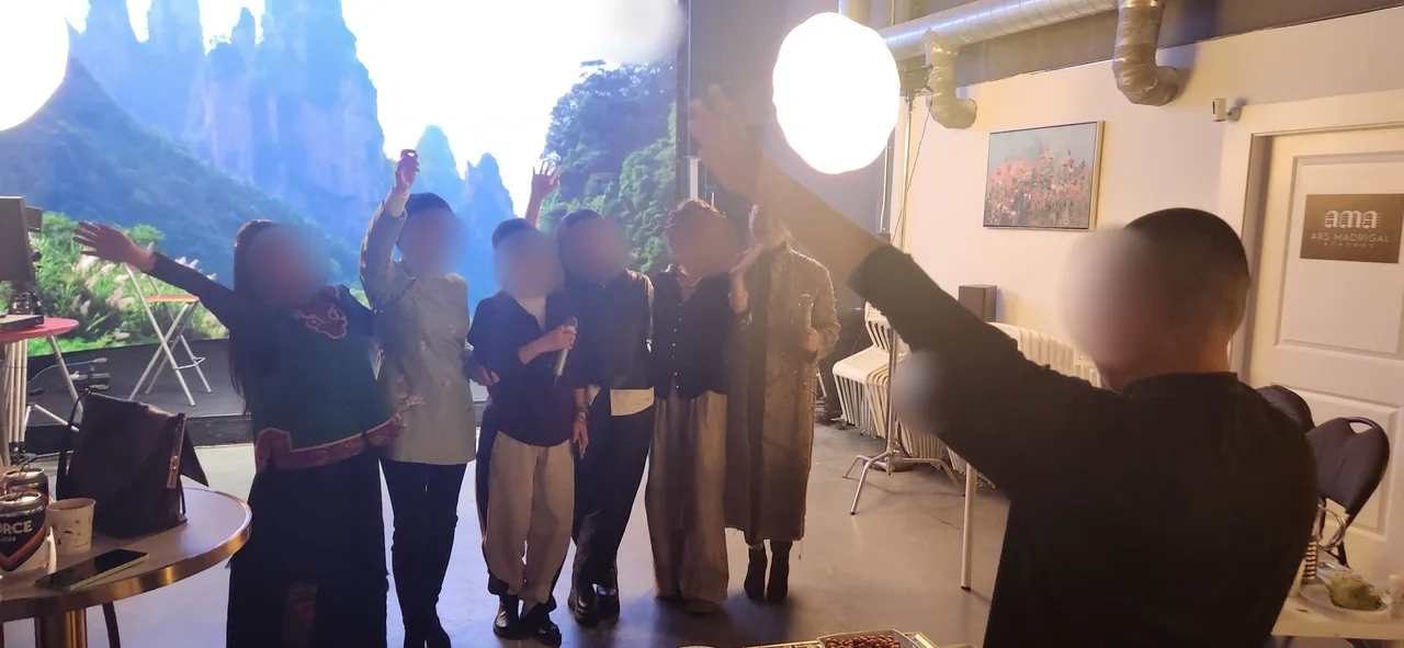 Women in Chinese-style dress posing for a group photo in front of a karst mountain backdrop on the LED wall at Upperland Studio, Richmond BC