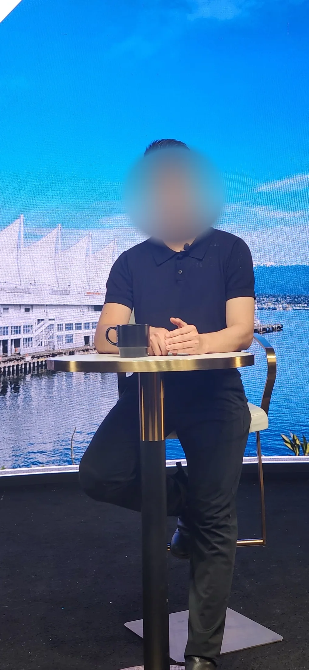 Presenter recording at a high table against a Vancouver harbour backdrop on the LED wall at Upperland Studio, Richmond BC