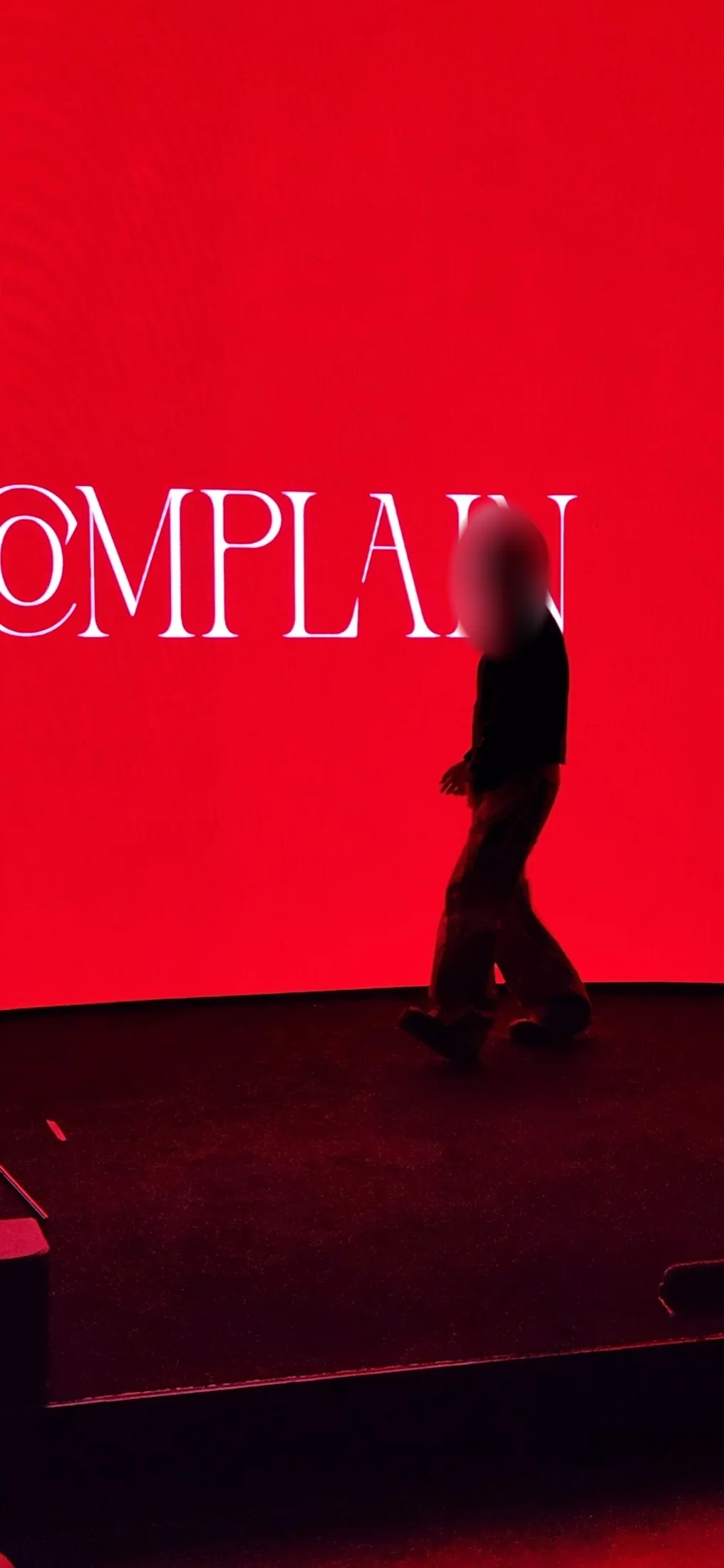 Silhouette of the artist walking across a red LED wall with lyric text, Upperland Studio Richmond BC