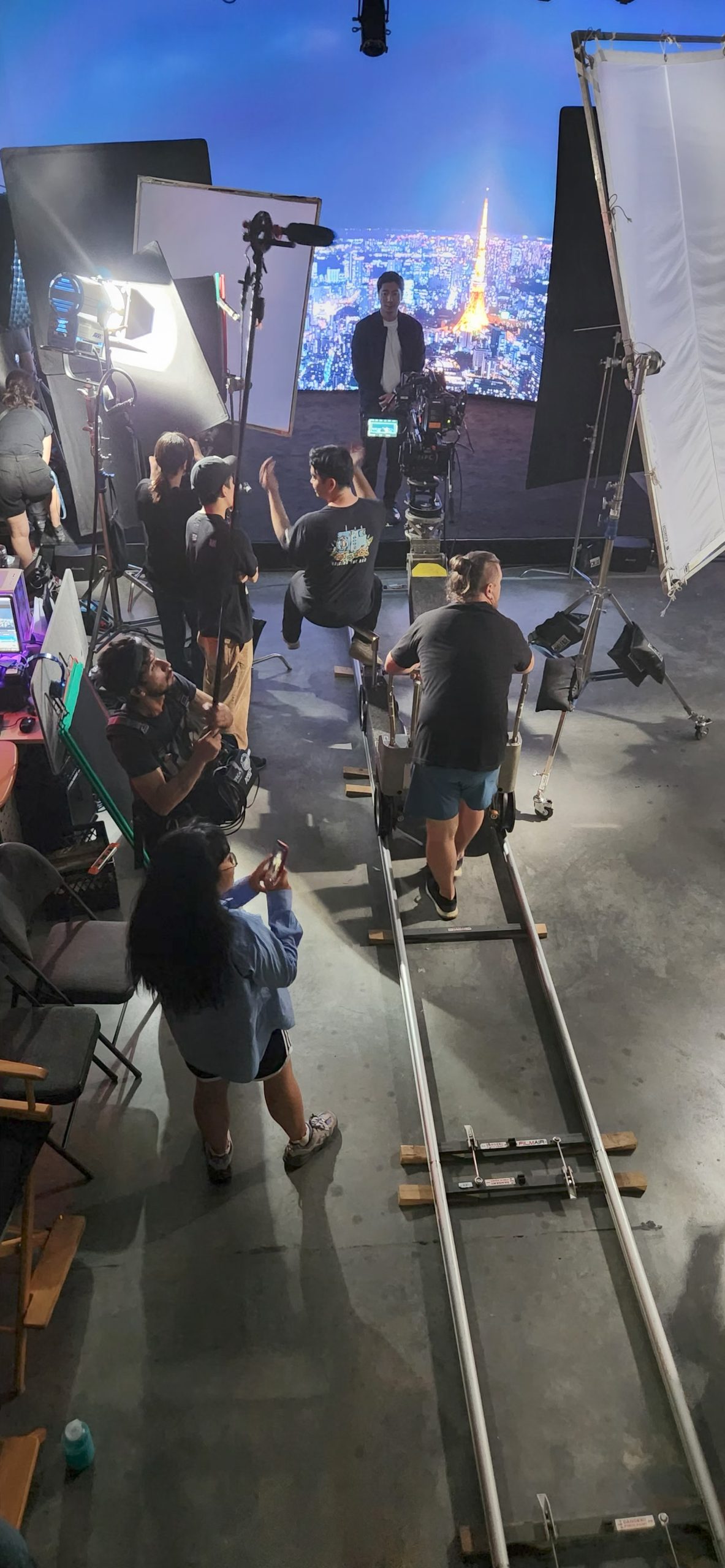 Behind the scenes of Stand In short film - LED wall virtual production at Upperland Studio displaying Tokyo skyline with film crew and dolly track