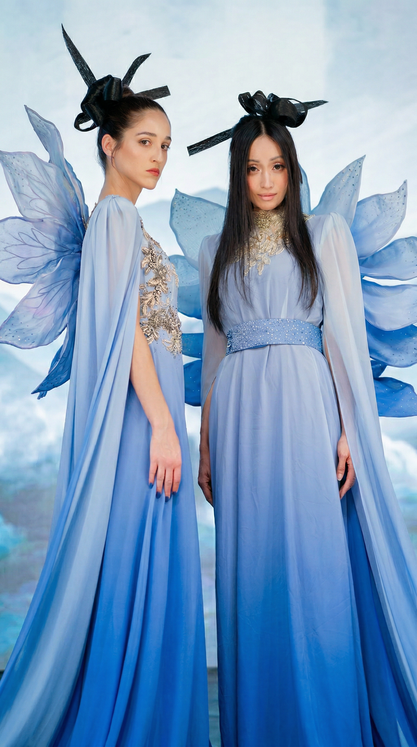 Two models in Xiangyan Couture blue New Chinese gowns with petal wings, misty mountain LED virtual production backdrop at Upperland Studio Vancouver